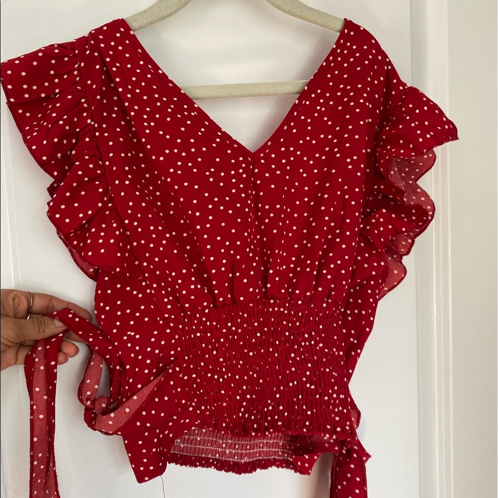 Woman’s red and white polka dot blouse. Can fit XS-M. Only ever worn once